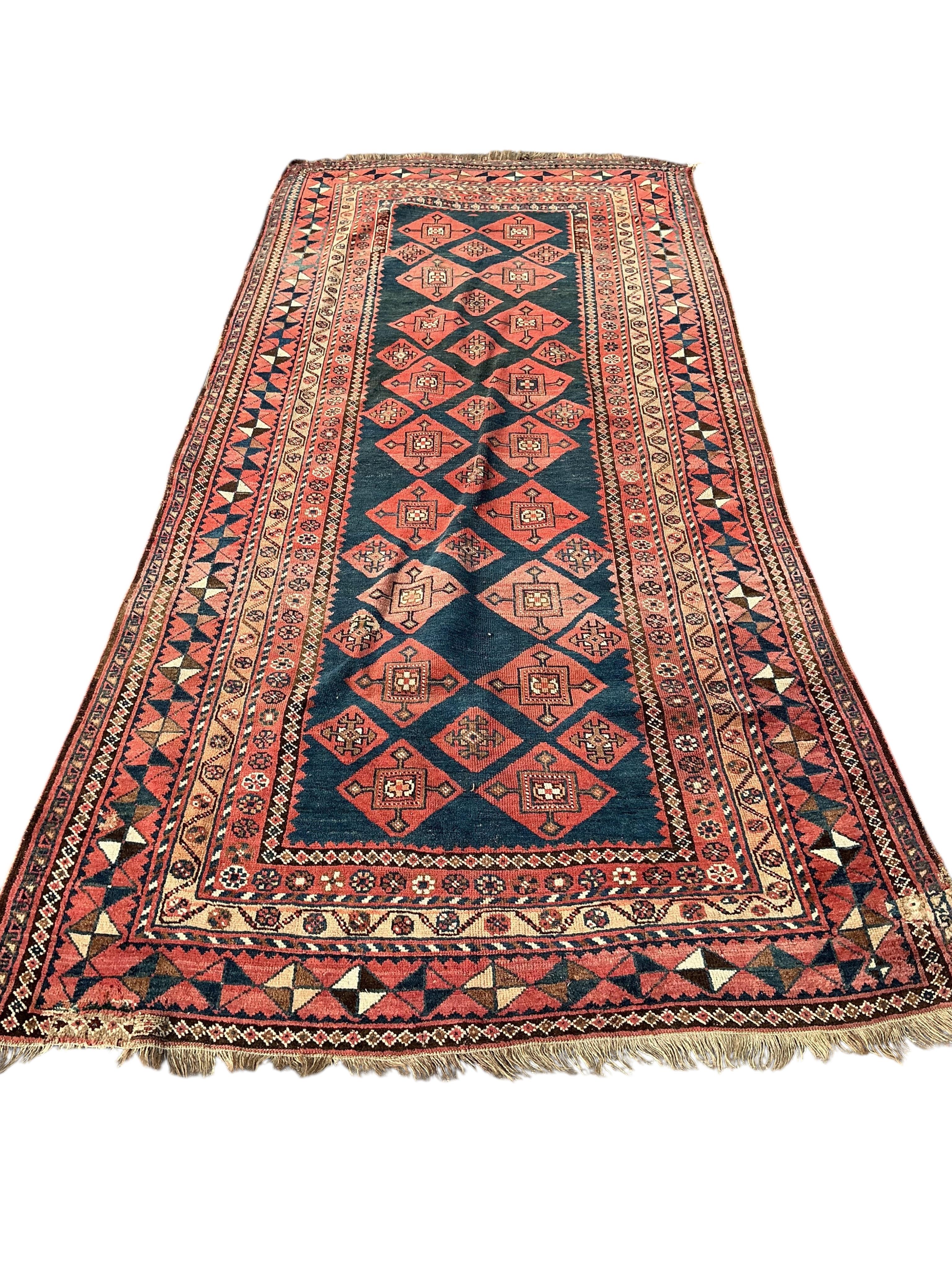 A Belouch blue ground hall carpet, 325cm x 145cm